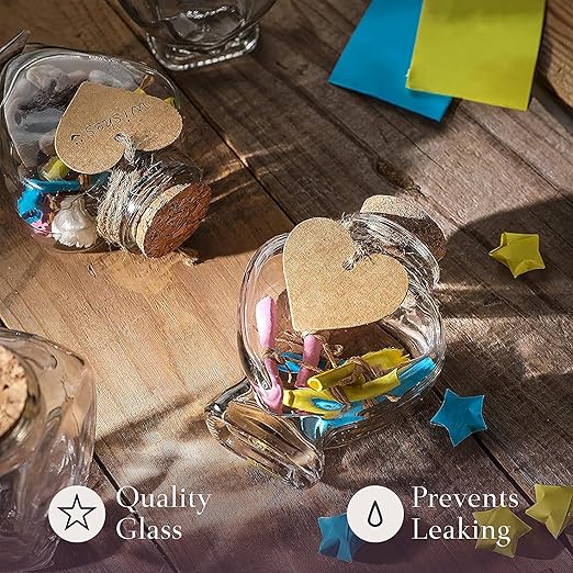 Set of 12 Heart Shaped Glass Jars with Cork Lids by WHOLE HOUSEWARES - Mini Bottles with String and Heart Labels - Small Spell Jars for Wedding Favors, Keepsakes, Potions and Valentine's Day Gifts